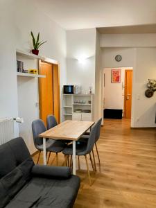 a living room with a wooden table and chairs at Edelweiss Apartments in Villach