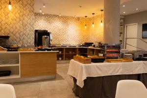 a large kitchen with a table in a restaurant at Hotel Puerta del Mar - Adults Recommended in Nerja