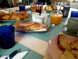 a table topped with plates of bread and orange juice at La Maison Poésie in Blay +14 photos