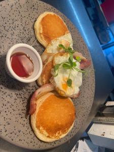a plate of breakfast food with eggs and bacon at Golf Links House in Newcastle +11 photos