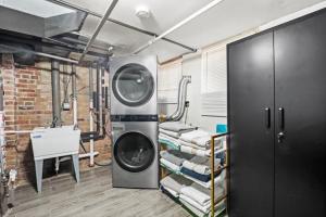 a laundry room with a washing machine and towels at Hamaline Luxury Guest House in Chicago