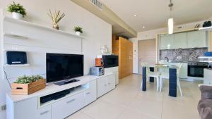 un soggiorno con una grande televisione e un tavolo di Suite Gallipoli con vista mare da 4 posti e wifi a Gallipoli Altre 42 foto