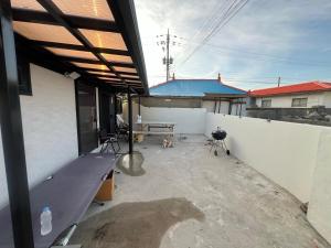 an outdoor patio with a bench and a table at Hupori Bagkol Minbak in Uljin