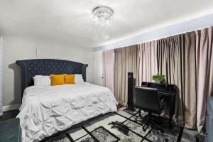a bedroom with a bed with yellow pillows and a desk at Hamaline Luxury Guest House in Chicago