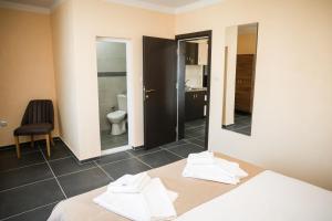 a room with a bed and a bathroom with a toilet at Hotel Santa Ria in Kŭrdzhali +59 photos