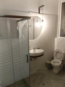 a bathroom with a sink and a toilet at Helene Mirteni in Ialyssos