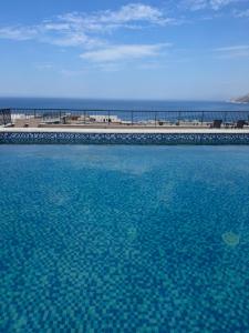 a large pool of blue water next to a beach at AD Home in Bar