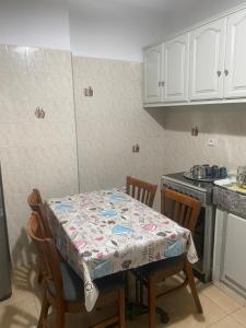 a kitchen with a table with a table cloth on it at Appartement Najma in Tangier +4 photos