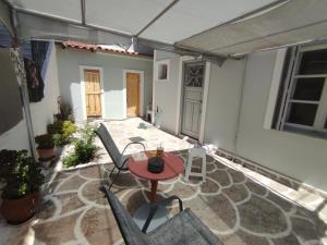 a patio with a table and chairs in a building at Apartments in Amarynthos - Evoia in Amarynthos