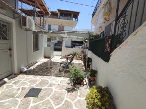 an outdoor patio with a table and an umbrella at Apartments in Amarynthos - Evoia in Amarynthos +7 photos