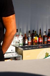 a group of bottles of alcohol on a counter at Hotel Puerta del Mar - Adults Recommended in Nerja