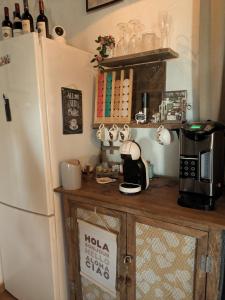 a kitchen with a refrigerator and a counter with a microwave at Casa KiSi Cottage, Rural Boutique Bed & Breakfast in Málaga
