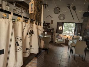 a restaurant with a table and chairs in a room at Casa KiSi Cottage, Rural Boutique Bed & Breakfast in Málaga