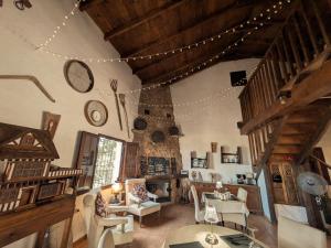 a living room filled with furniture and a ceiling at Casa KiSi Cottage, Rural Boutique Bed & Breakfast in Málaga