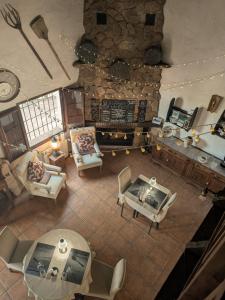 an overhead view of a living room with a stone fireplace at Casa KiSi Cottage, Rural Boutique Bed & Breakfast in Málaga