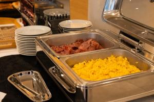 a tray of food with meat and eggs in it at Hotel Puerta del Mar - Adults Recommended in Nerja