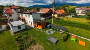an aerial view of a house in a village at Ubytovanie na Trojke in Liptovský Ondrej