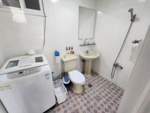 a small bathroom with a toilet and a sink at 글렌즈게스트하우스 in Daegu