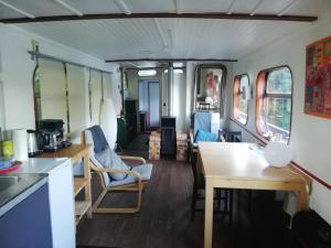 a room with a table and chairs in a train car at Botel La Vecchia (LY1992) in Dole