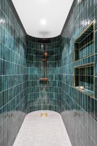 a green tiled shower with a mattress in a bathroom at The Townhouse Dream I No Expense Spared I NEW 2025 in Bergen