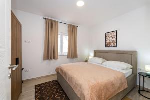 a bedroom with a bed and a window at Apartment Deluxe Vir in Vir