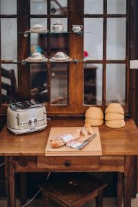 a table with a toaster and bread on it at Château de KERVOAZEC - Chambres d'hôtes in Saint-Goazec
