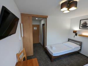 Postel nebo postele na pokoji v ubytování Hotel Antoň