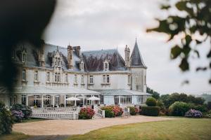 a large building with a fence in front of it at Château de KERVOAZEC - Chambres d'hôtes in Saint-Goazec