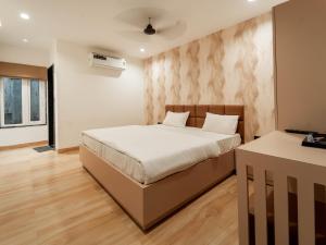 a bedroom with a bed and a desk in it at Flare By Blaze in Bhopal +37 photos