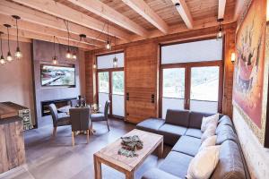 a living room with a couch and a table at Wellness Ferienhaus “Lotus II” in Rieden