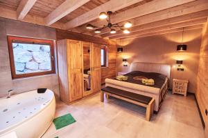 a bedroom with a tub and a bed in a room at Wellness Ferienhaus “Lotus II” in Rieden