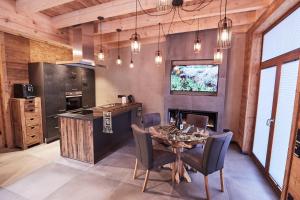 a dining room with a table and a kitchen at Wellness Ferienhaus “Lotus II” in Rieden