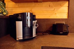 a coffee maker and a printer sitting on a counter at Chang Haus in Rieden +20 photos