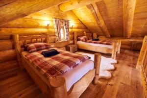 a bedroom with two beds in a log cabin at Eifelblockhaus in Rieden
