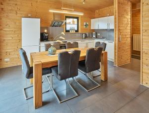 a kitchen with a wooden table and chairs at Eifelzeit in Rieden