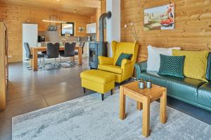 a living room with a couch and chairs and a table at Eifelzeit in Rieden