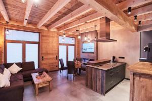 a kitchen and living room with a couch and a table at Wellness Ferienhaus “Lotus I” in Rieden