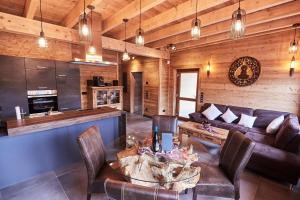 a living room with a couch and a table at Wellness Ferienhaus “Lotus I” in Rieden
