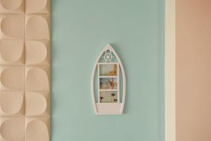 a doll house with a mirror on a wall at Apartment RELAX in the city center in Yambol