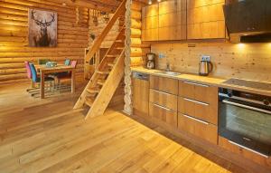 a kitchen with a staircase in a log cabin at Seezeit Chalet in Rieden +18 photos