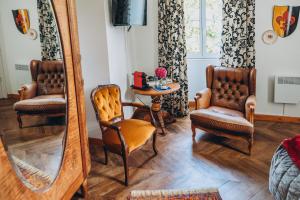 a room with two chairs and a mirror at Château de KERVOAZEC - Chambres d'hôtes in Saint-Goazec