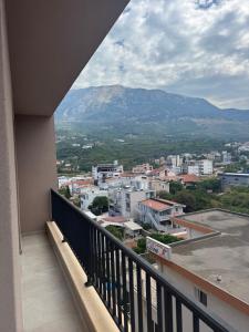 a balcony with a view of a city and mountains at AD Home in Bar
