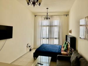 a living room with a bed and a couch at Not far from metro and WTC in Dubai +5 photos