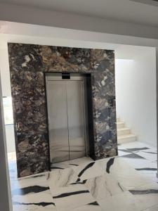a door in a room with a stone wall at AD Home in Bar