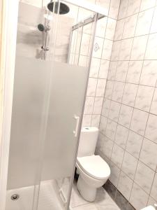 a white bathroom with a toilet and a shower at Casa Rosalina in Longwy