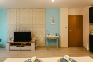a living room with a television and a table at Apartment RELAX in the city center in Yambol