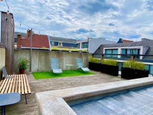 a patio with two chairs and a table on a building at ROOOm Kortrijk in Kortrijk
