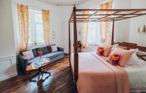 a bedroom with a bed and a couch at Château de KERVOAZEC - Chambres d'hôtes in Saint-Goazec +87 photos