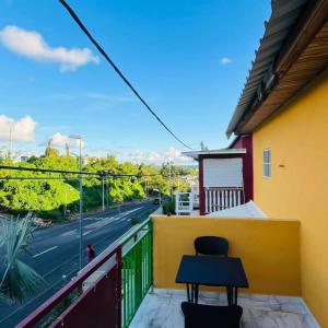 a table on a balcony with a view of a street at Steiladay hébergement 976 in Pamandzi