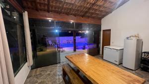 a dining room with a table and a pool at Chácara Bella Vista Mairinque in Mairinque